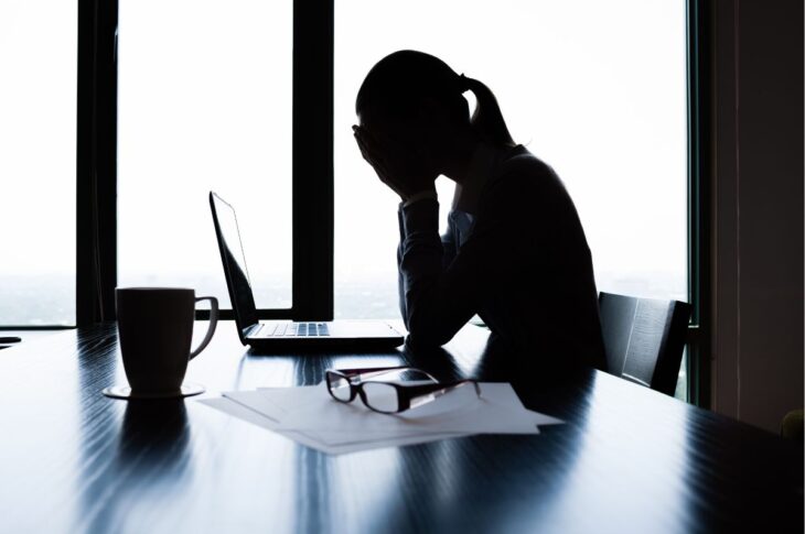 Stressed young business woman in the office.