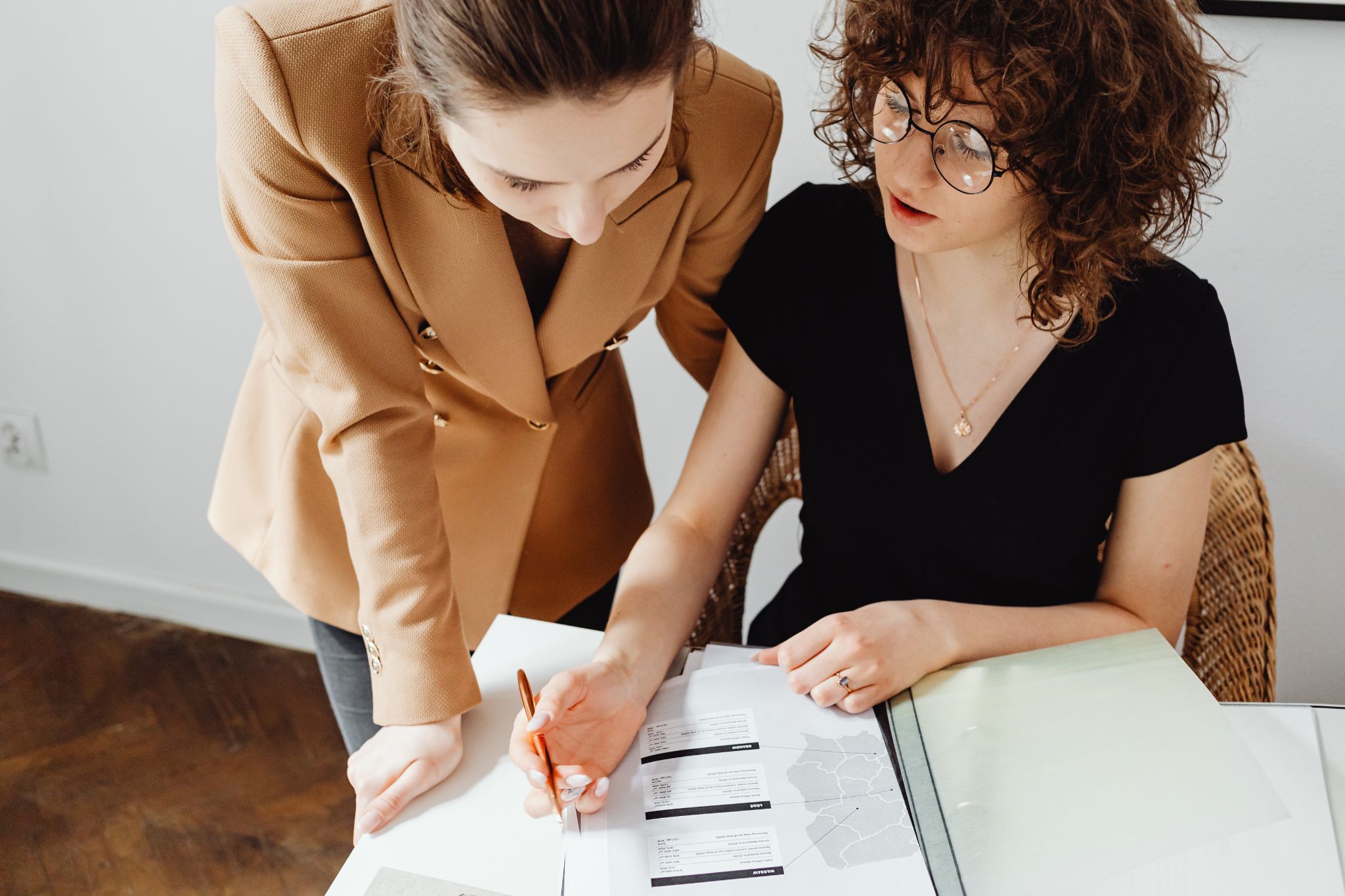Two women completing paperwork